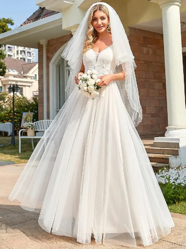 Gloria Ivory/nude tulle wedding gown with beading